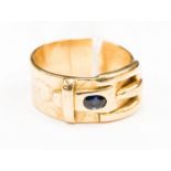A 9ct gold gents buckle ring set with two sapphires either side of the buckle,