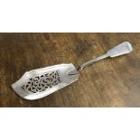 An early Victorian provincial Exeter silver fish slice in a fiddle pattern with pierced foliate
