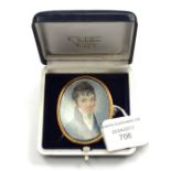 A 19th Century oval portrait miniature brooch depicting a young gentlemen, yellow metal surround,