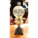 A late 19th century brass and cast iron oil lamp,