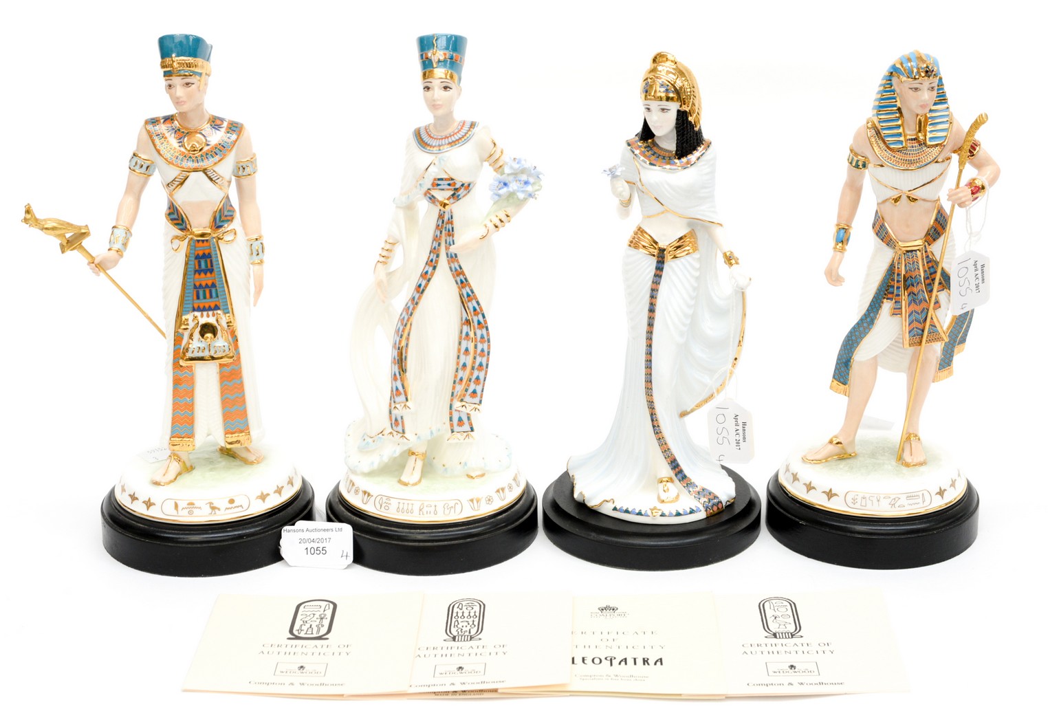 A set of four Egyptian figurines including certificates and plinths,