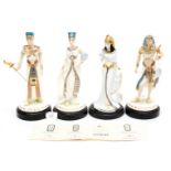 A set of four Egyptian figurines including certificates and plinths,