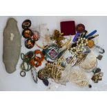 An assortment of vintage costume jewellery to include bead necklaces, brooches,