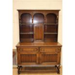 An early 20th Century dresser with rack, the rack having a centre door,