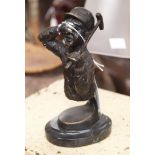 Golfing interest, a bronze figure holding an iron,