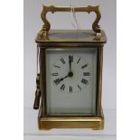 An early 20th century brass carriage timepiece (key)