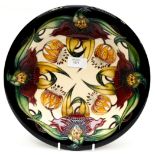 A Moorcroft shallow dish in the Anna Lily pattern, designed by Nicola Slaney,