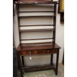 An early 20th Century mahogany dresser, adapted, the rack with two plate shelves,