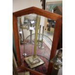 A mahogany framed mirror for wall attachment,