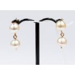 A pair of double pearl drop earrings on 9ct gold