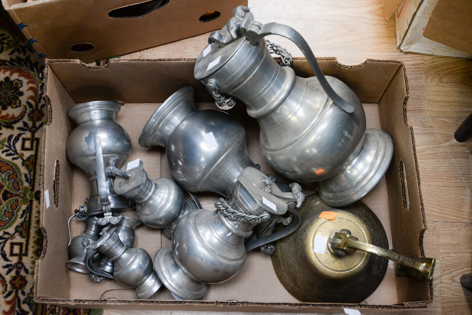 A quantity of Continental pewter beer jugs with lids,