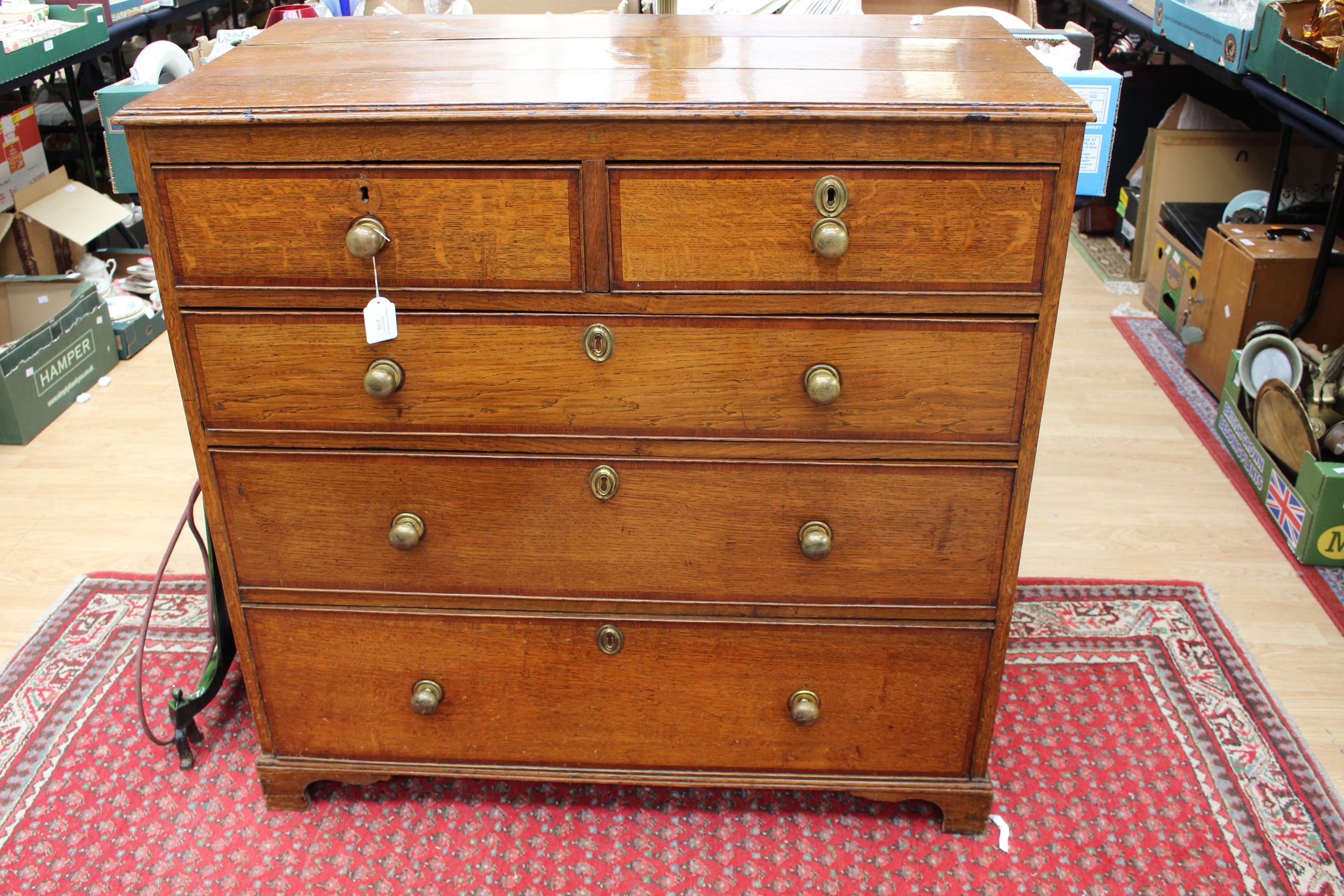 A George III oak and mahogany chest of drawers,