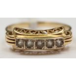A 14ct gold ring set with five white stones, possibly, white sapphires.