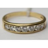 An 18ct seven stone diamond channel set ring, size U with a total gross weight approx 3.