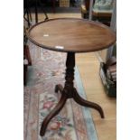 An early 19th Century mahogany pedestal snap top table