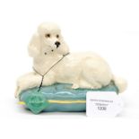 A Beswick Poodle on turquoise cushion with label