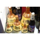 Graduated set of Bells whisky decanters 75cl to miniature,