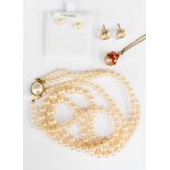 A double strand of simulated pearls with silver gilt fastener;