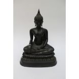 A Chinese bronze figure of Buddah, sitting on a double Lotus throne,