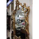 A Baroque stye gilt wood framed wall mirror,