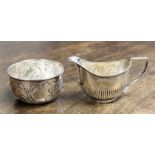 An embossed silver bowl, Birmingham 1906, maker William Devenport, with a silver cream jug,
