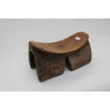 Tribal art, a 19th Century African tribal wooden head rest, of dished from on four bracket feet,