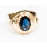 A blue sapphire single stone yellow gold signet ring with diamond set shoulders with triangle shape