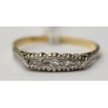 An 18ct and platinum diamond set boat ring set with five small diamonds.Total gross weight approx 2.