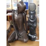 A pair of decorative figurines to comprise: a cold painted figure of a seated lady (hand broken)