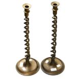 A pair of mid - Victorian Gothic style tall bronze - finish candlesticks with twist-design stems,