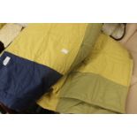 A blue, green, acid yellow patchwork quilt,
