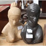 A pair of re-constituted carved stone busts, one in cream,