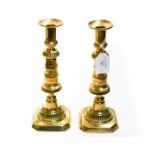 A pair of mid Victorian brass candlesticks, with pushers,