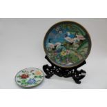 Two Chinese cloisonné plaques, one with stand, ten inches/16 cm approx diameter and 14¾ inches/37.