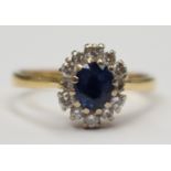 A sapphire and diamond oval cluster 18ct yellow gold ring,