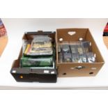 A collection of model tanks within plastic cases;