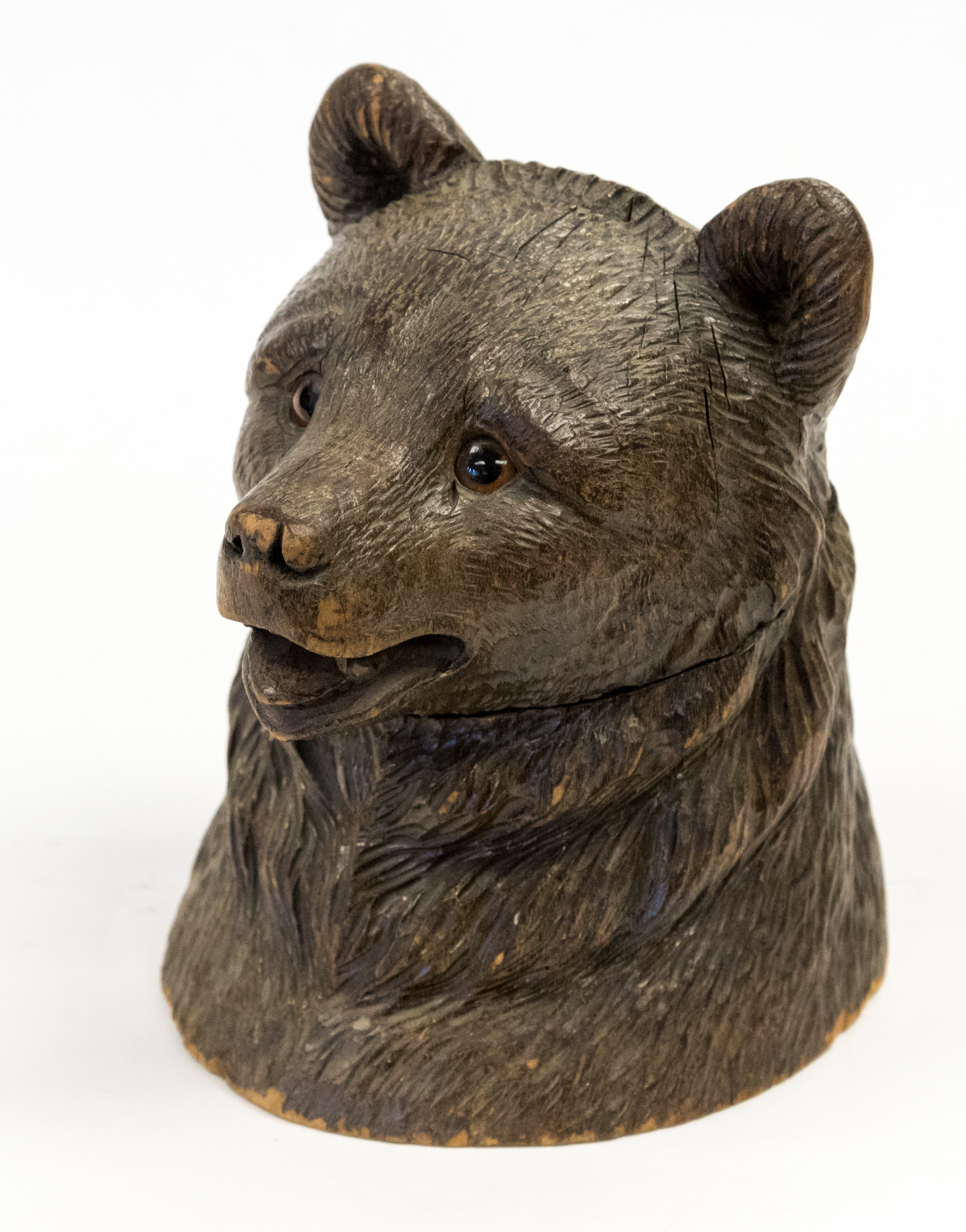 A Black Forest carved inkwell in the form of a bears head,