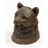 A Black Forest carved inkwell in the form of a bears head,