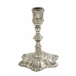 An 18th Century candlestick, possibly Paktong, ball knop with six petals,