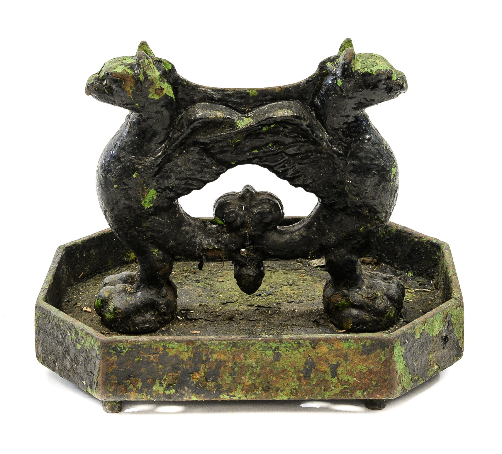 A 19th century cast iron boot scraper, twin griffin form within an octagonal tray,