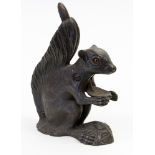 A cast iron squirrel nut cracker, spring action movement, with glass eyes,