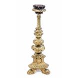 A gilt gesso Spanish style pricket stick, tricorn body with paw feet,