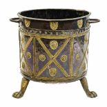 A 19th century copper and brass log or coal bin, cylindrical form, on three lions paw feet,