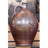 A very large stoneware glazed bellermine bottle with multiple cartouche cast dates of C1623,