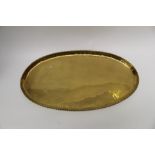 Hugh Wallis, an Arts and Crafts brass oval tray with rope twist border, stamped march,