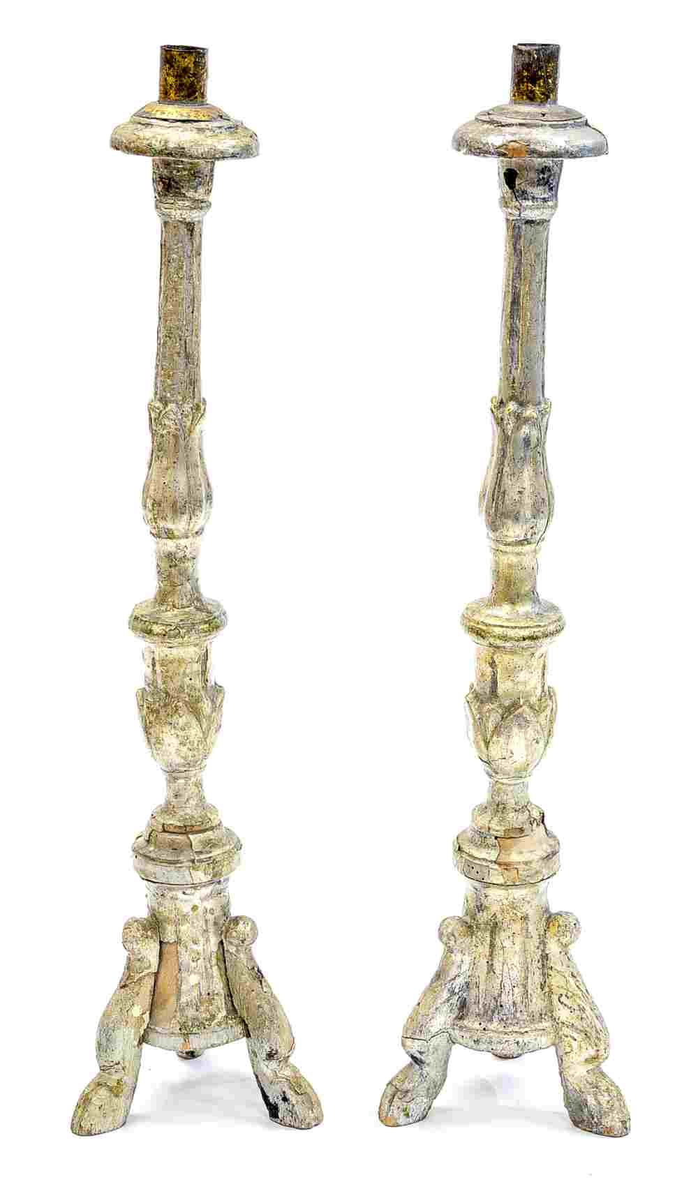 A pair of carved wood and Gesso Spanish style candlesticks, distressed with silvered paint,