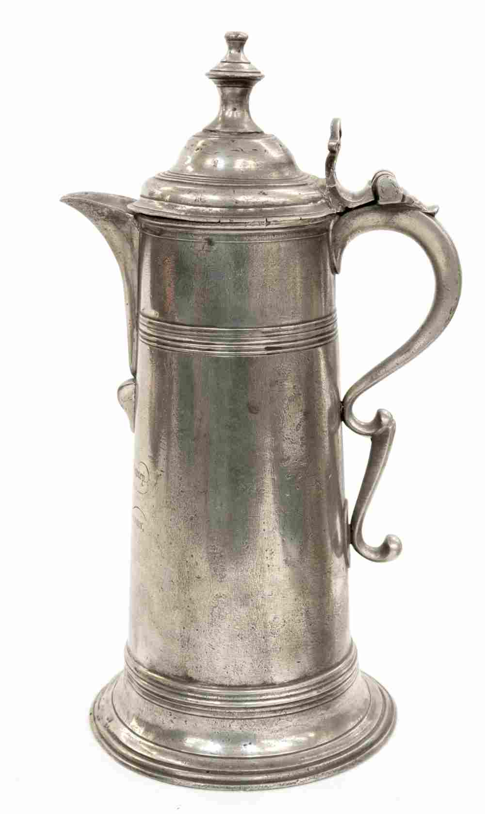 A tall spouted pewter spire flagon made in London in the early 19th Century,