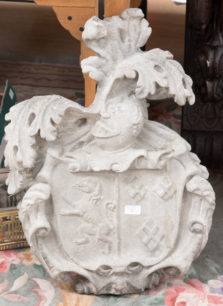 A carved limestone armorial, 19th century, with coat of arms within a foliate cartouche,