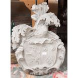 A carved limestone armorial, 19th century, with coat of arms within a foliate cartouche,