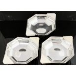 Three Art Deco silver plated and ivorine occasional dishes, octagonal section, on pedestal feet,